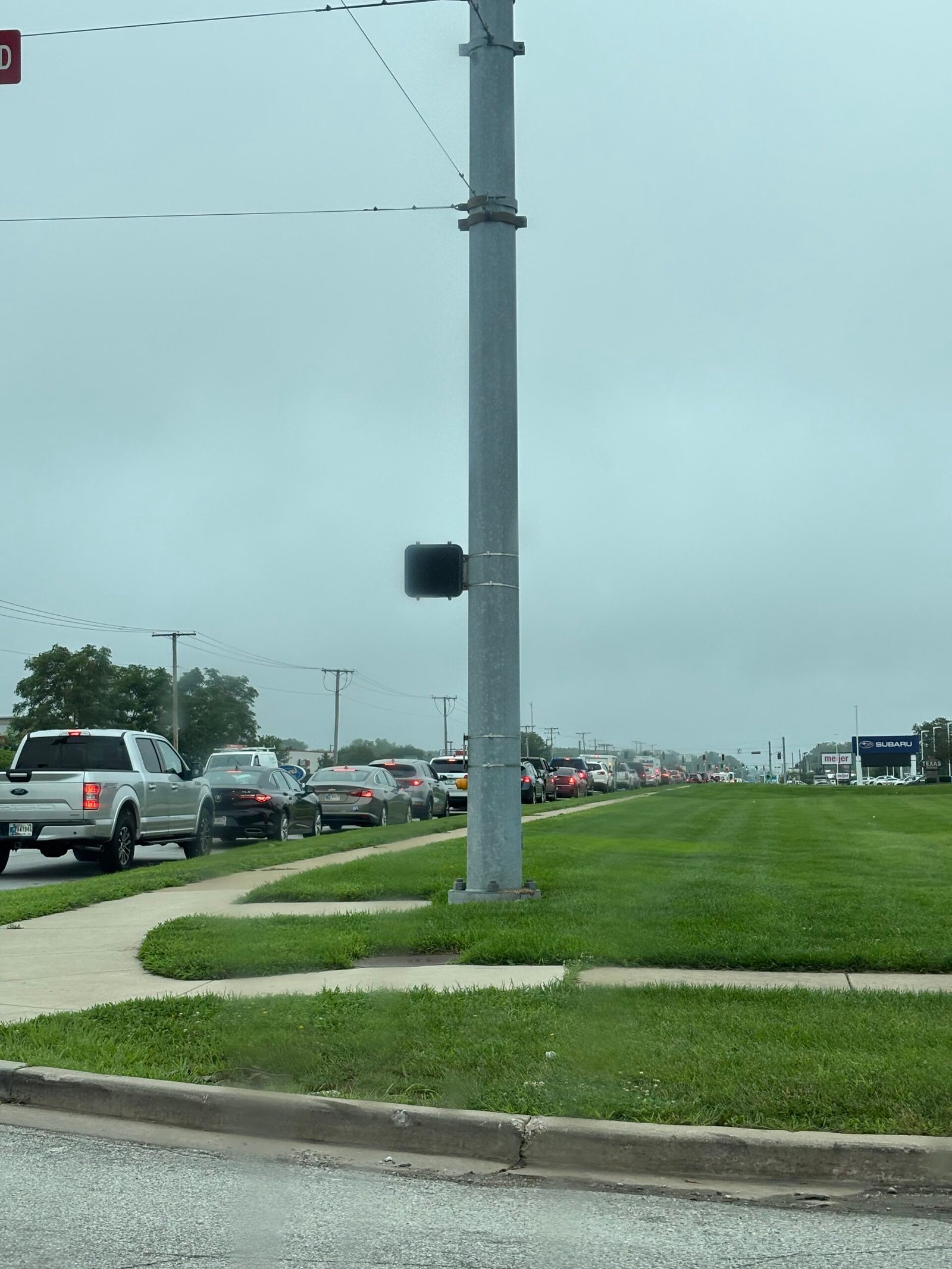 Long line of cars waiting for gas after the derecho power outages